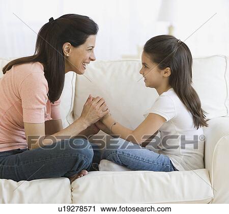 Mother and daughter smiling at each other View Large Photo Image Stock Image - Mother and daughter smiling at each other. Fotosearch