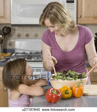 Stock Image - Mother and daughter smiling at each other. Fotosearch