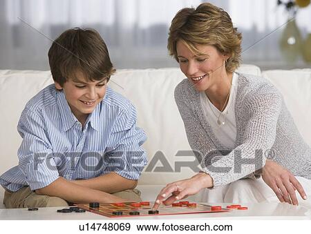 Stock Photo - Mother and son playing checkers. Fotosearch