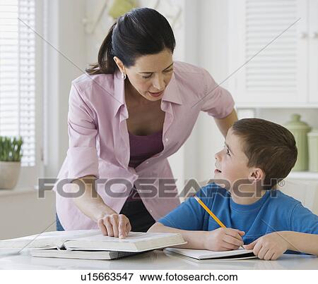 Mother helping son with homework View Large Photo Image Stock Photo - Mother helping son with homework. Fotosearch