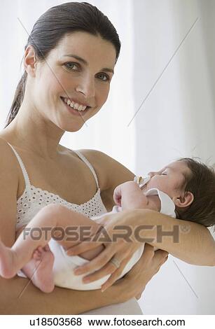 Mother holding baby View Large Photo Image Stock Photo - Mother holding baby. Fotosearch