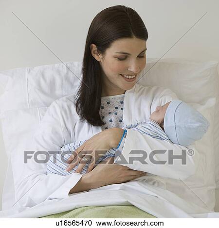 Mother holding newborn in hospital View Large Photo Image Stock Image - Mother holding newborn in hospital. Fotosearch