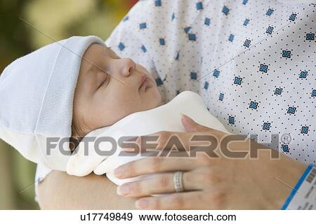 Stock Photo - Mother holding newborn in hospital. Fotosearch