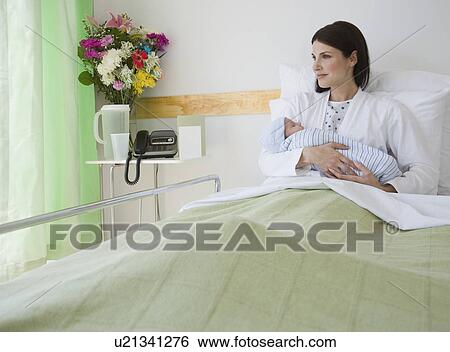 Stock Photograph - Mother holding newborn in hospital. Fotosearch