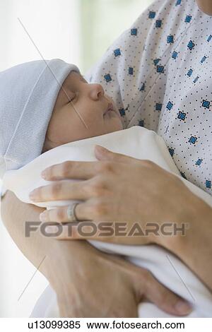 Stock Photography - Mother holding newborn in hospital. Fotosearch