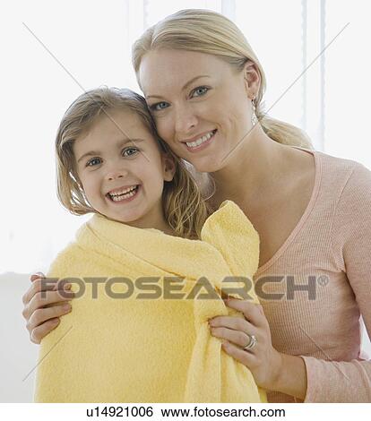 Mother hugging daughter wrapped in towel View Large Photo Image Stock Photograph - Mother hugging daughter wrapped in towel. Fotosearch