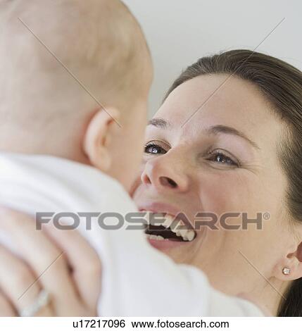 Stock Photograph - Mother laughing at baby. Fotosearch