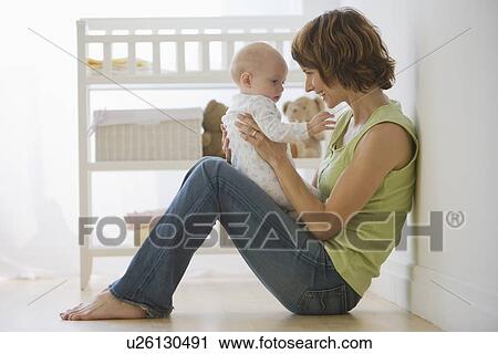 Mother playing with baby View Large Photo Image Stock Image - Mother playing with baby. Fotosearch