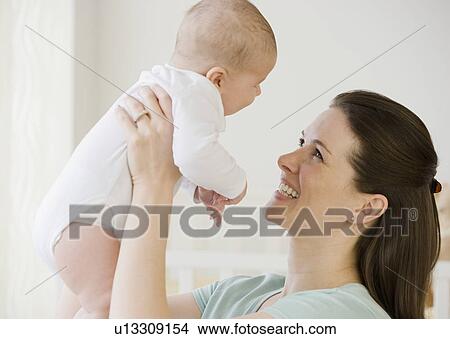Mother smiling at baby View Large Photo Image Picture - Mother smiling at baby. Fotosearch