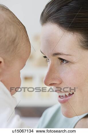 Mother smiling at baby View Large Photo Image Picture - Mother smiling at baby. Fotosearch