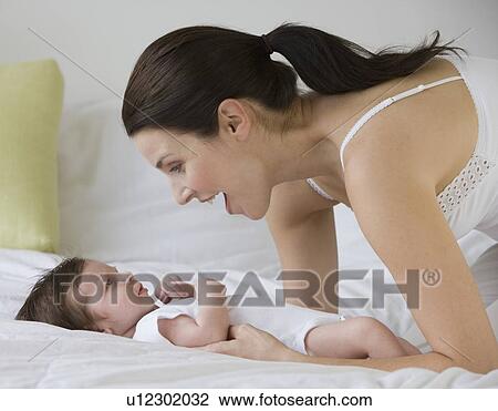 Mother smiling at baby View Large Photo Image Stock Image - Mother smiling at baby. Fotosearch
