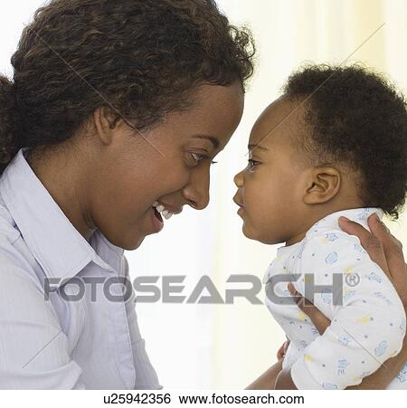 Stock Photograph - Mother smiling at baby. Fotosearch