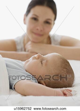 Mother watching baby sleep View Large Photo Image Stock Image - Mother watching baby sleep. Fotosearch