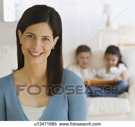 Stock Photography - Mother with children in background. Fotosearch