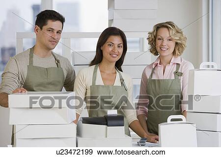Stock Photo - Multi-ethnic bakery workers behind counter. Fotosearch