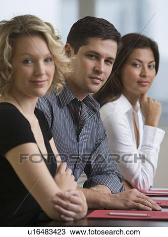 Stock Image - Multi-ethnic businesspeople at meeting. Fotosearch
