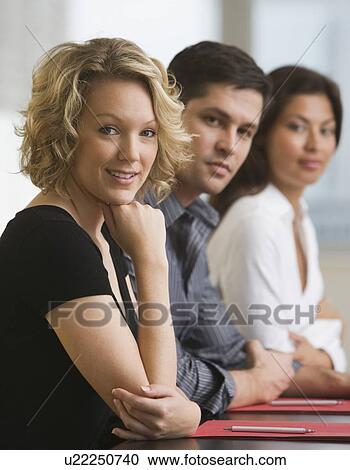 Stock Image - Multi-ethnic businesspeople at meeting. Fotosearch