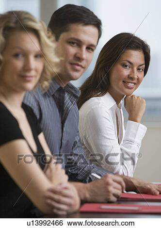 Stock Photograph - Multi-ethnic businesspeople at meeting. Fotosearch