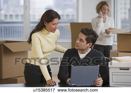 Stock Photo - Multi-ethnic businesspeople in new office. Fotosearch