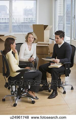 Stock Photo - Multi-ethnic businesspeople in new office. Fotosearch