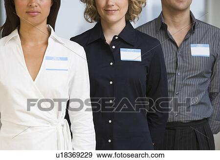 Multi-ethnic businesspeople wearing name tags View Large Photo Image Stock Photo - Multi-ethnic businesspeople wearing name tags. Fotosearch