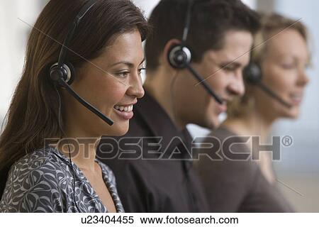 Multi-ethnic businesspeople wearing headsets View Large Photo Image Stock Photography - Multi-ethnic businesspeople wearing headsets. Fotosearch