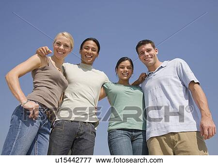 Multi-ethnic friends arm in arm View Large Photo Image Stock Photo - Multi-ethnic friends arm in arm. Fotosearch