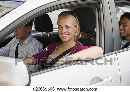 Stock Image - Multi-ethnic friends driving in car. Fotosearch