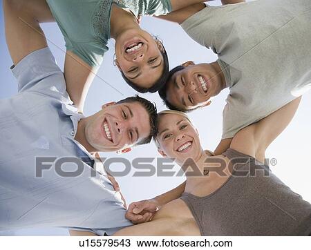 Multi-ethnic friends in huddle View Large Photo Image Stock Image - Multi-ethnic friends in huddle. Fotosearch