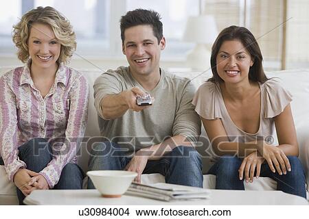 Multi-ethnic friends watching television View Large Photo Image Picture - Multi-ethnic friends watching television. Fotosearch