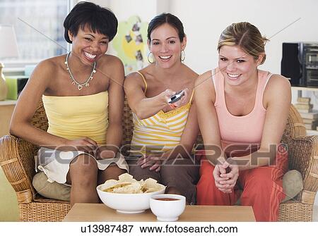 Multi-ethnic women watching television View Large Photo Image Stock Photo - Multi-ethnic women watching television. Fotosearch