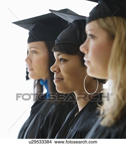 Multi-ethnic women wearing graduation cap and gown View Large Photo Image Picture - Multi-ethnic women wearing graduation cap and gown. Fotosearch
