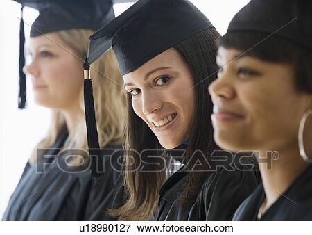 Multi-ethnic women wearing graduation cap and gown View Large Photo Image Stock Photo - Multi-ethnic women wearing graduation cap and gown. Fotosearch