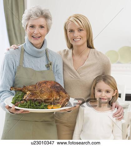 Stock Photo - Multi-generational female family members at Thanksgiving. Fotosearch