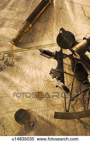 Stock Photography - Octant, compass and telescope on nautical map. Fotosearch