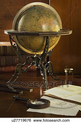 Stock Photograph - Old fashioned globe in stand on table. Fotosearch