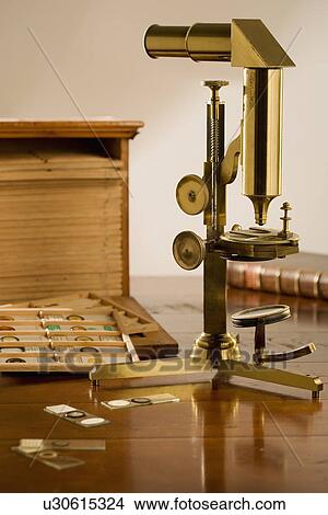 Picture - Old fashioned microscope and slides on table. Fotosearch