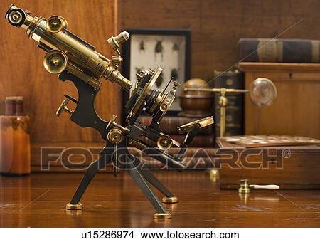 Picture - Old fashioned microscope on table. Fotosearch