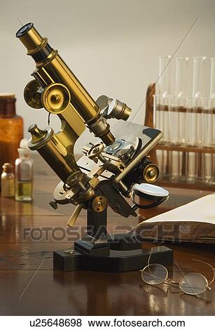 Old fashioned microscope on table View Large Photo Image Stock Photo - Old fashioned microscope on table. Fotosearch