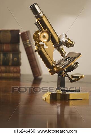 Old fashioned microscope on table View Large Photo Image Stock Photograph - Old fashioned microscope on table. Fotosearch