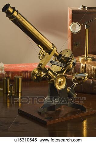 Stock Photography - Old fashioned microscope on table. Fotosearch