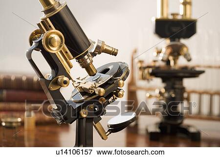 Stock Photo - Old fashioned microscopes on table. Fotosearch