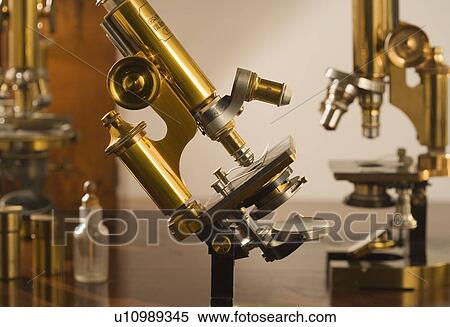 Stock Photography - Old fashioned microscopes on table. Fotosearch
