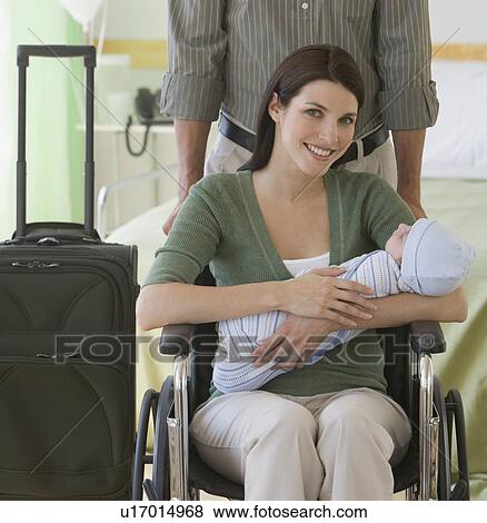 Stock Photo - Parents leaving hospital with newborn. Fotosearch