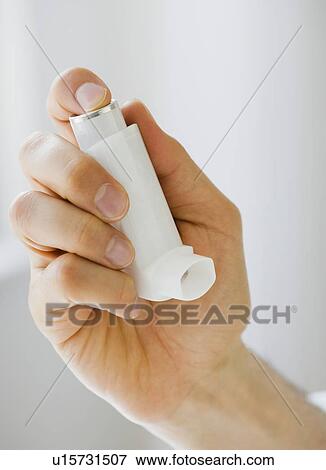 Person holding asthma inhaler View Large Photo Image Stock Photo - Person holding asthma inhaler. Fotosearch