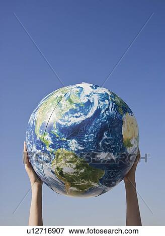Person holding globe in air View Large Photo Image Stock Photo - Person holding globe in air. Fotosearch