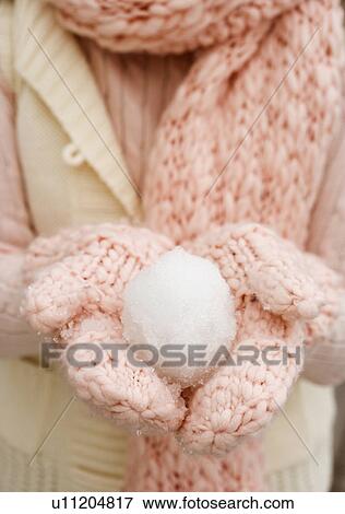 Person holding snowball in gloved hands View Large Photo Image Stock Photo - Person holding snowball in gloved hands. Fotosearch