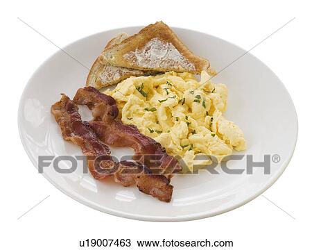 Stock Image - Plate of eggs, toast and bacon. Fotosearch