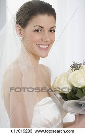 Portrait of bride holding bouquet View Large Photo Image Stock Image - Portrait of bride holding bouquet. Fotosearch