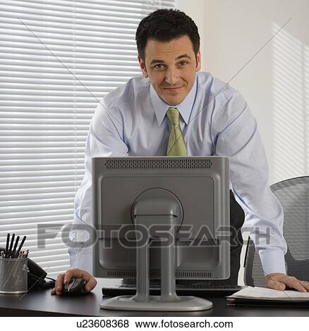 Portrait of businessman at desk View Large Photo Image Stock Photo - Portrait of businessman at desk. Fotosearch